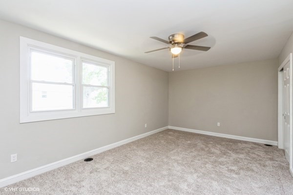 170-180 America Street Fall River, MA 02721 - Photo 19 of 40 a view of a room with a ceiling fan and a window