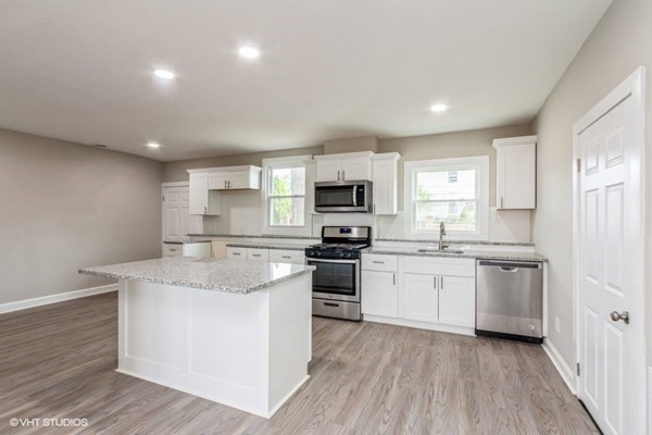 170-180 America Street Fall River, MA 02721 - Photo 25 of 40 a kitchen with a sink stove cabinets and refrigerator