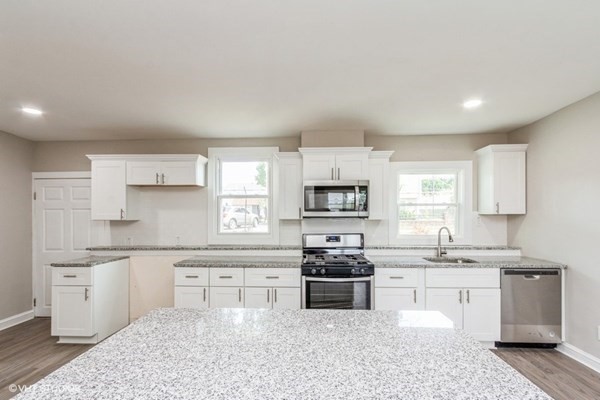 170-180 America Street Fall River, MA 02721 - Photo 27 of 40 a kitchen with stainless steel appliances a sink stove and cabinets