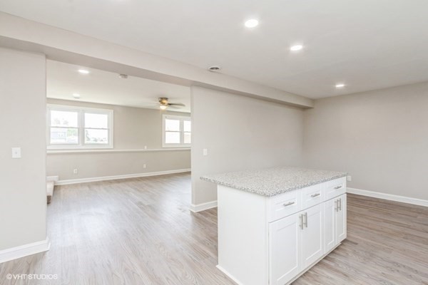 170-180 America Street Fall River, MA 02721 - Photo 30 of 40 an empty room with wooden floor and windows