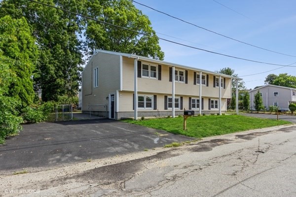 170-180 America Street Fall River, MA 02721 - Photo 3 of 40 a view of a house with a yard and large tree