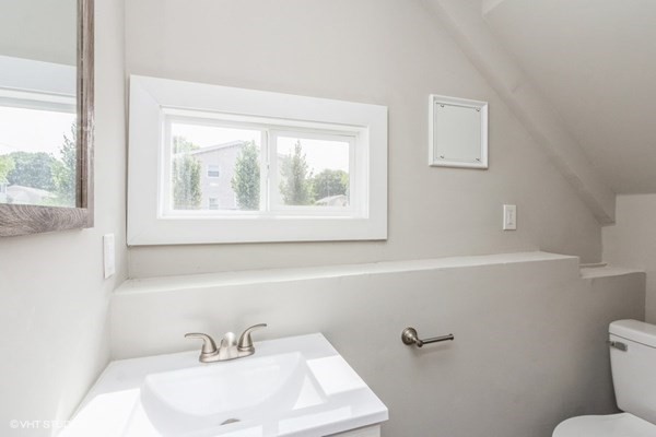 170-180 America Street Fall River, MA 02721 - Photo 31 of 40 a bathroom with a sink mirror and toilet