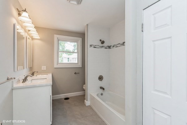 170-180 America Street Fall River, MA 02721 - Photo 32 of 40 a bathroom with a tub sink and mirror