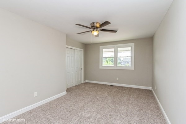 170-180 America Street Fall River, MA 02721 - Photo 33 of 40 an empty room with windows and ceiling fan