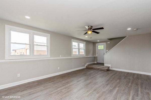 170-180 America Street Fall River, MA 02721 - Photo 4 of 40 an empty room with wooden floor and windows