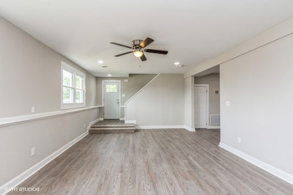 170-180 America Street Fall River, MA 02721 - Photo 5 of 40 an empty room with wooden floor ceiling fan and windows