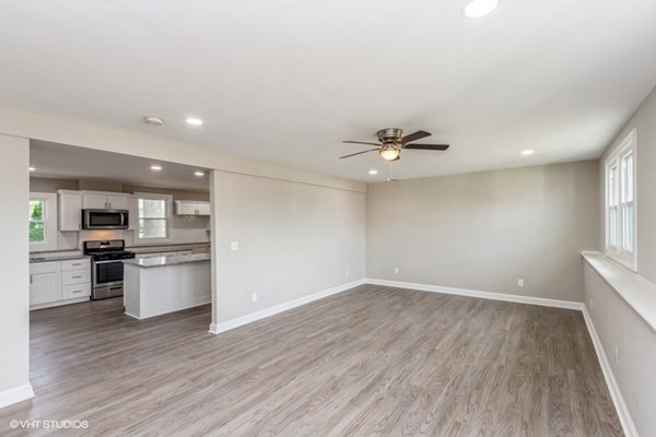 170-180 America Street Fall River, MA 02721 - Photo 6 of 40 a view of a kitchen with a stove cabinets and wooden floor