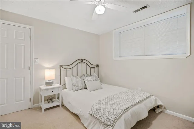 a bedroom with a bed and a night stand