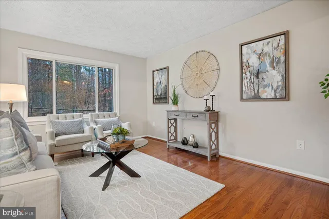 a living room with furniture a window and a potted plant