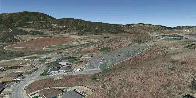 an aerial view of a house with a mountain