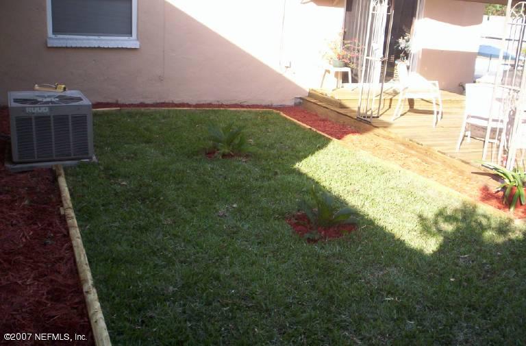 2411 Sam Road Jacksonville, FL 32216 - Photo 14 of 14 a backyard of a house with lots of green space