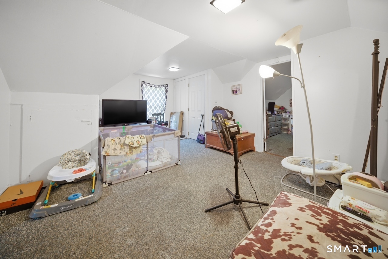 12 Webster Street Vernon, CT 06066 - Photo 22 of 33 a room with gym equipment and a flat screen tv