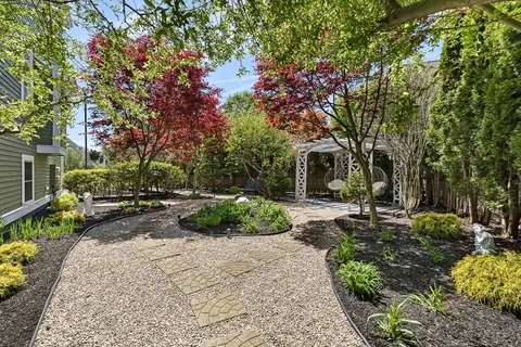 a view of backyard with outdoor seating and trees