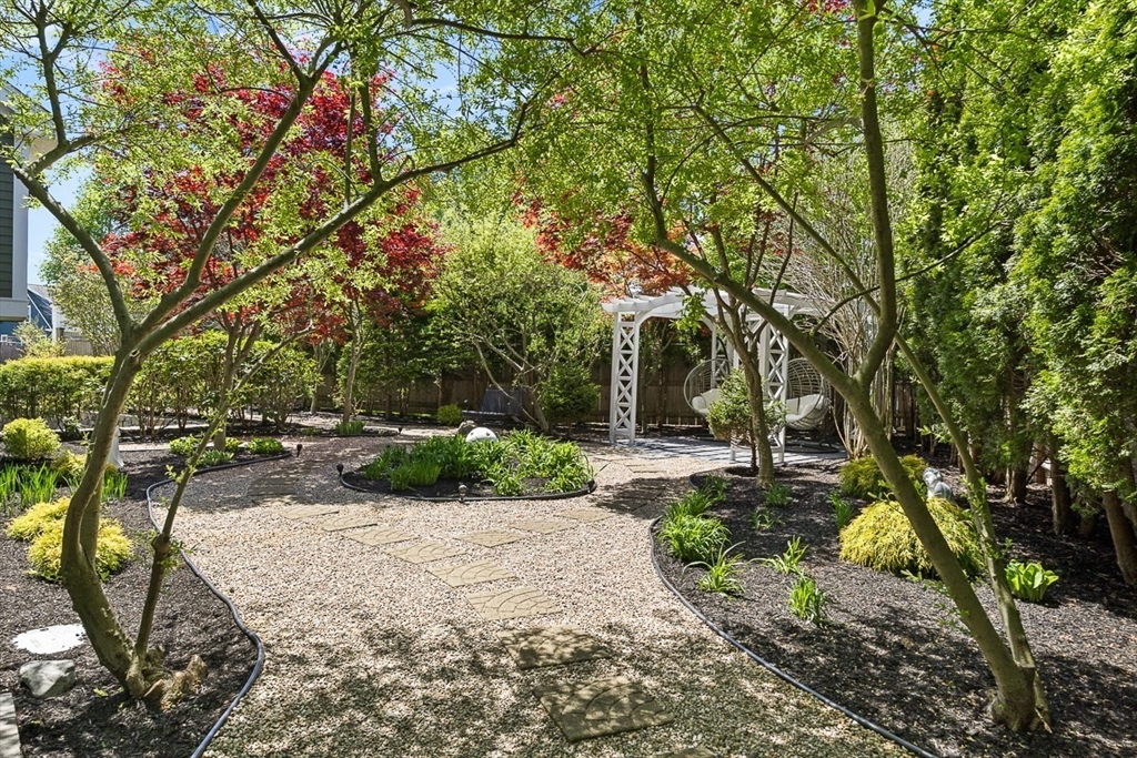 7 Sherman Place, Unit 7 Winchester, MA 01890 - Photo 37 of 40 a view of backyard with outdoor seating and trees
