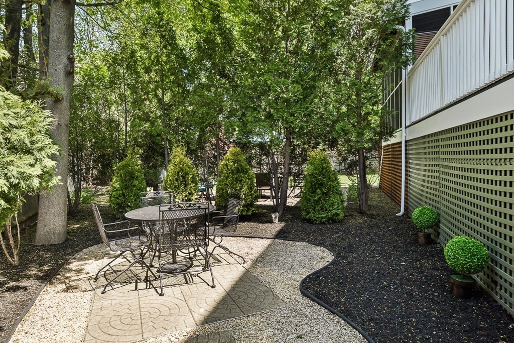 7 Sherman Place, Unit 7 Winchester, MA 01890 - Photo 39 of 40 a view of a backyard with sitting area