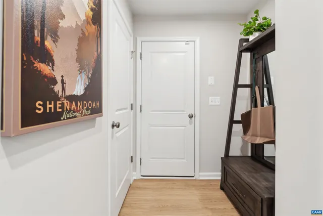 a view of hallway with stairs and wooden floor