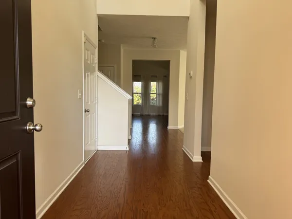 a view of a hallway with wooden floor