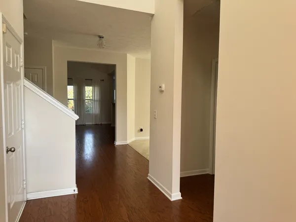a view of a hallway with wooden floor