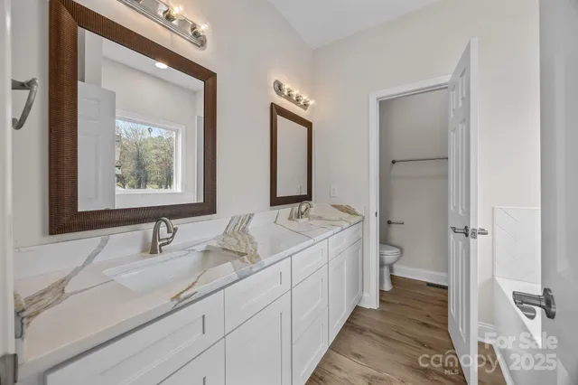 a bathroom with a double vanity sink and mirror
