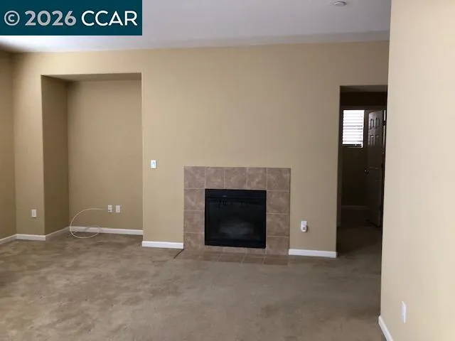 a view of an empty room with a fireplace