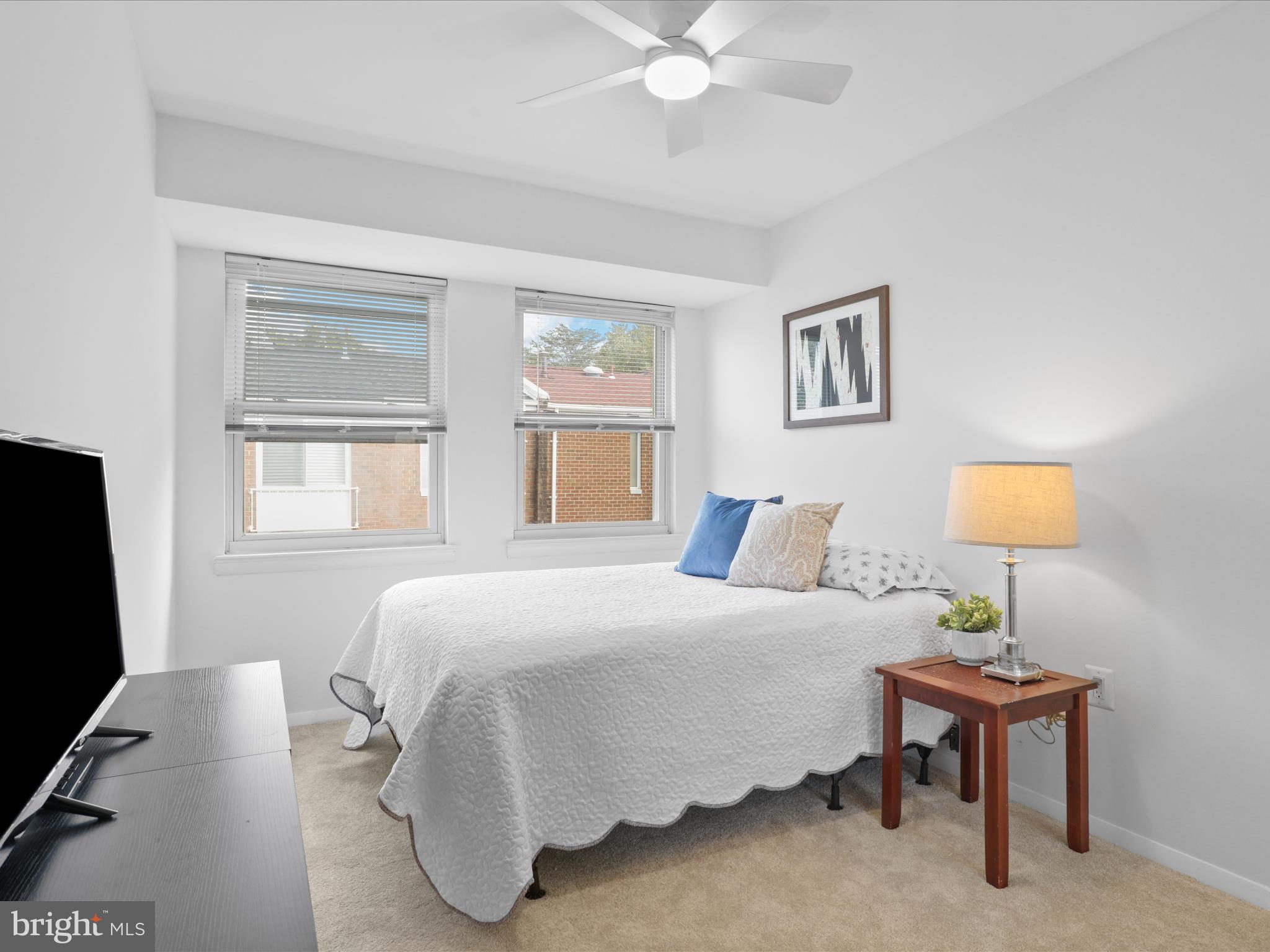 246 Stevenson Square Alexandria, VA 22304 - Photo 15 of 31 a bedroom with a bed and a flat tv screen on a dresser