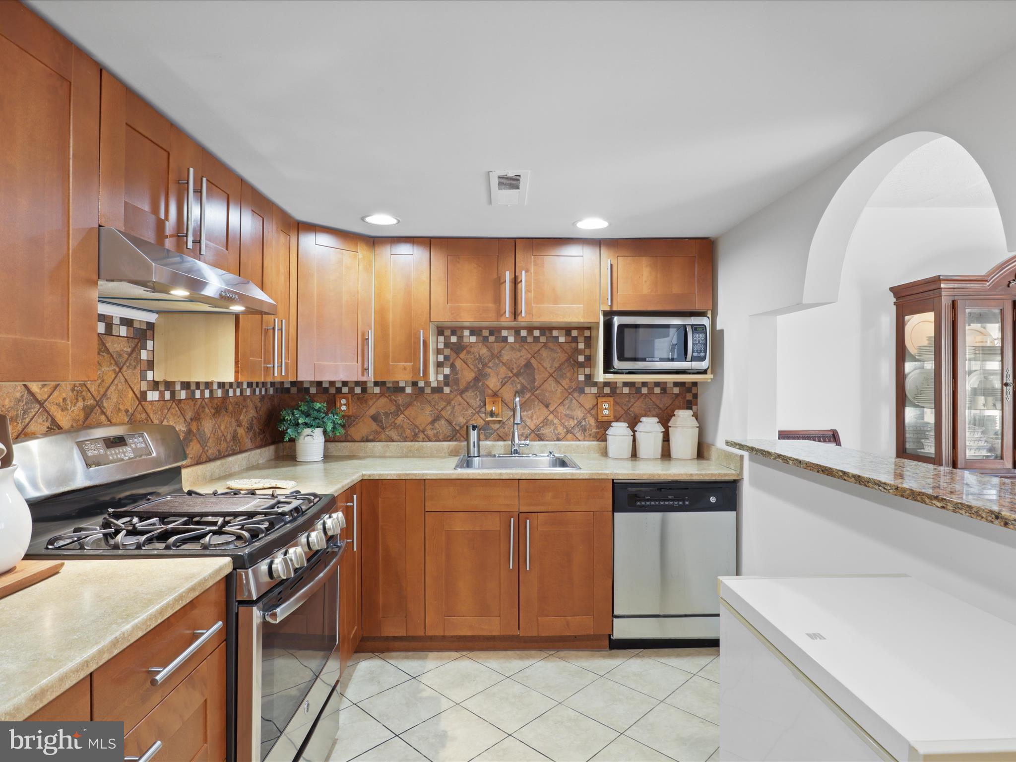 246 Stevenson Square Alexandria, VA 22304 - Photo 6 of 31 a kitchen with stainless steel appliances granite countertop a stove a sink and a refrigerator