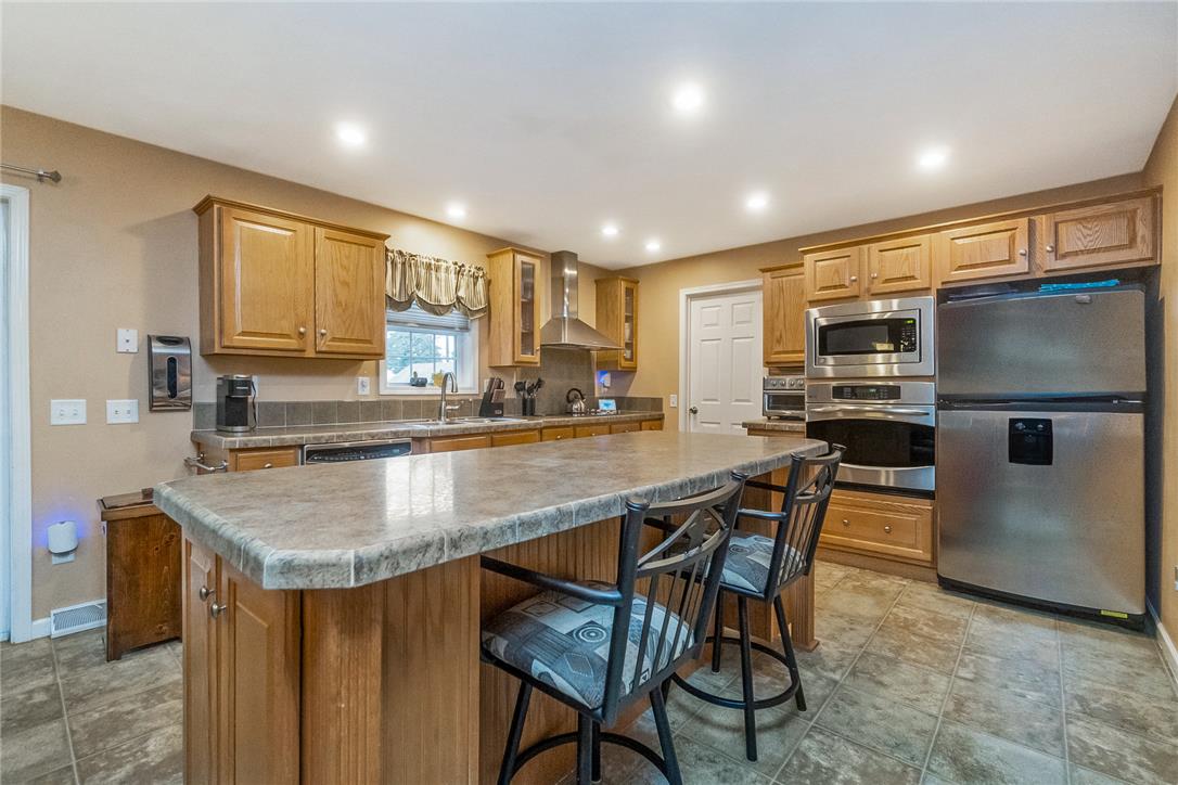 514 Norman Road Nazareth, PA 18064 - Photo 14 of 41 Warm wood cabinetry and a central island highlight this well-equipped kitchen space.