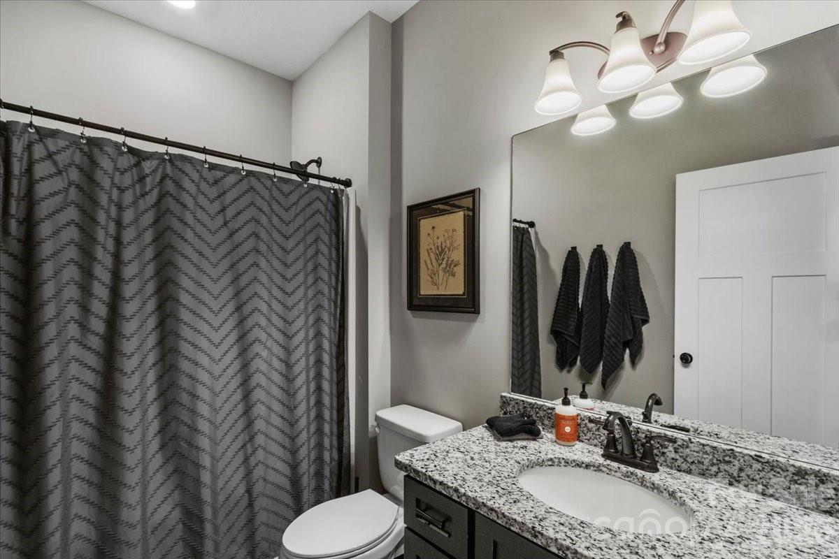 36 Cherry Ridge Lane Weaverville, NC 28787 - Photo 28 of 37 a bathroom with a granite countertop sink toilet and a mirror