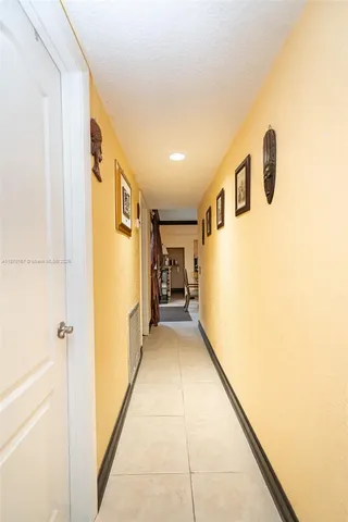 a view of walk in closet with wooden floor and door