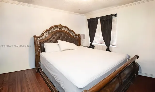 a front view of a multi story residential apartment building with yard and green space