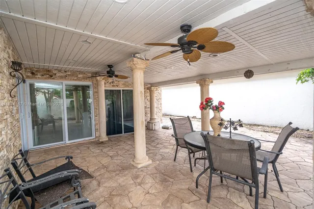 an aerial view of a house with a yard and potted plants
