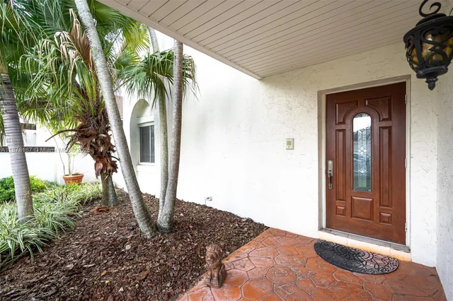 a living room with furniture a flat screen tv and a large window