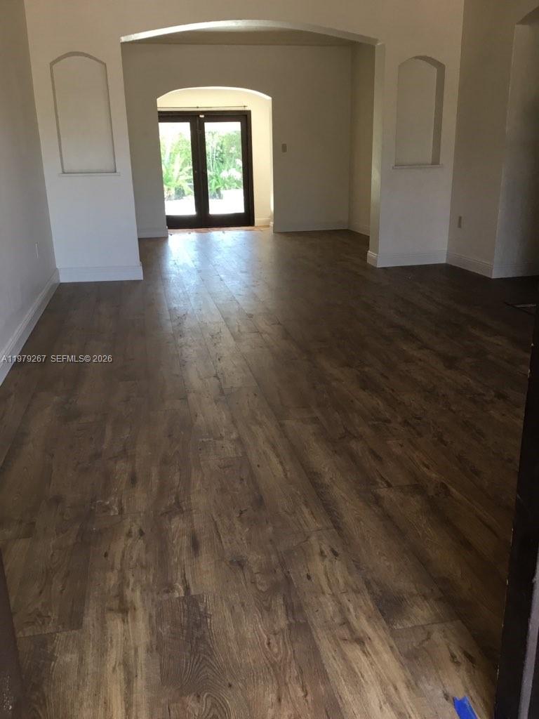 8927 Hawthorne Avenue Surfside, FL 33154 - Photo 17 of 40 an empty room with wooden floor and windows