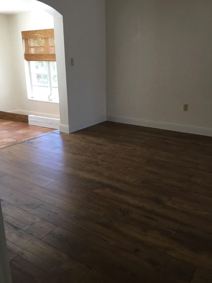 8927 Hawthorne Avenue Surfside, FL 33154 - Photo 19 of 40 an empty room with wooden floor and windows