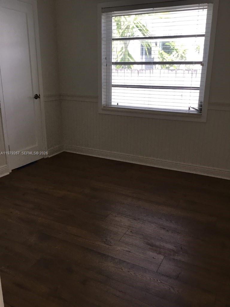 8927 Hawthorne Avenue Surfside, FL 33154 - Photo 20 of 40 an empty room with wooden floor and windows