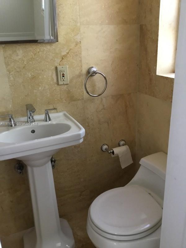 8927 Hawthorne Avenue Surfside, FL 33154 - Photo 21 of 40 a bathroom with a sink a toilet and a mirror