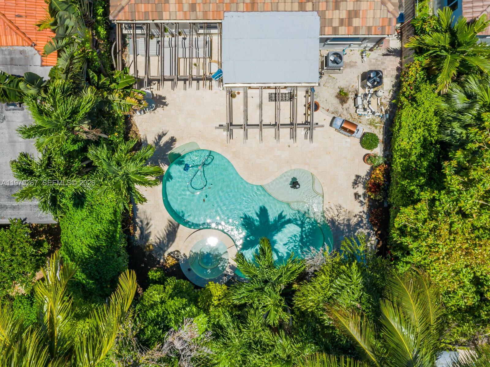 8927 Hawthorne Avenue Surfside, FL 33154 - Photo 28 of 40 a view of a swimming pool with sitting area and garden