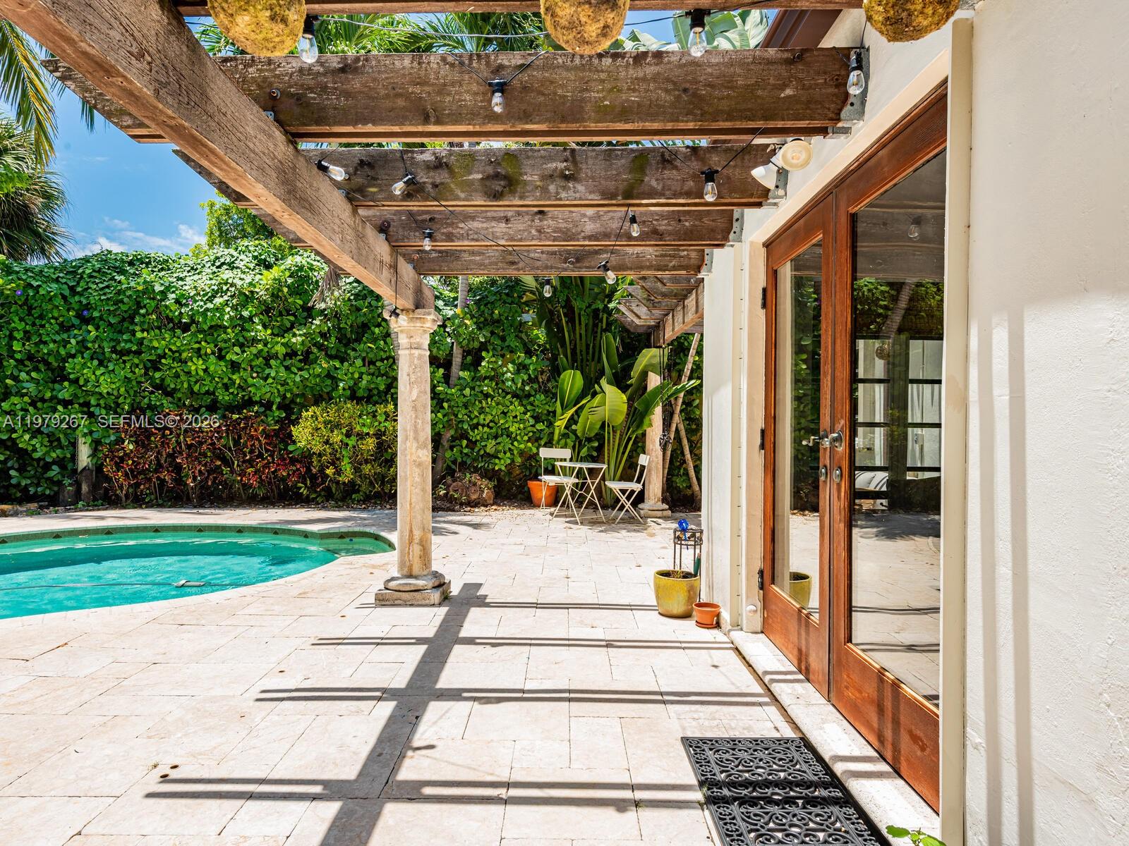 8927 Hawthorne Avenue Surfside, FL 33154 - Photo 7 of 40 a view of a patio with a table and chairs