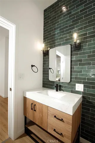 a bathroom with a double vanity sink mirror and toilet