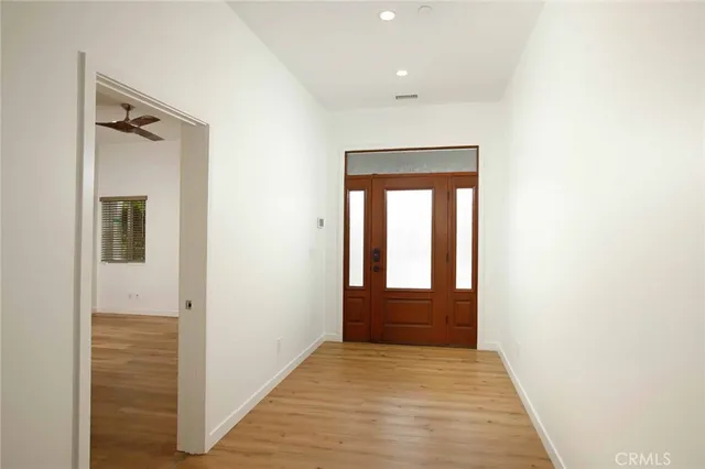an empty room with wooden floor and fireplace