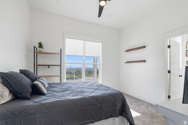 2013 South 100 West Perry, UT 84302 - Photo 19 of 49 Bright interior space featuring a large window with roller shades, white walls, and light-toned carpeting