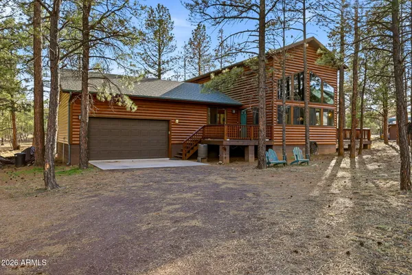 a view of a house with a yard and wooden fence