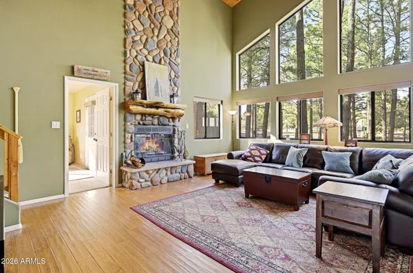 a view of deck with large trees and wooden fence