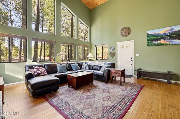 a living room with fireplace furniture and a wooden floor