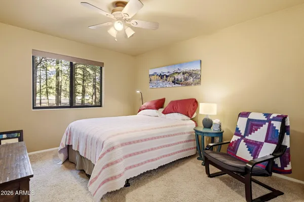a bathroom with double vanity sink a mirror and a shower