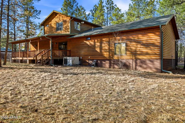 a view of a house with a small yard and furniture