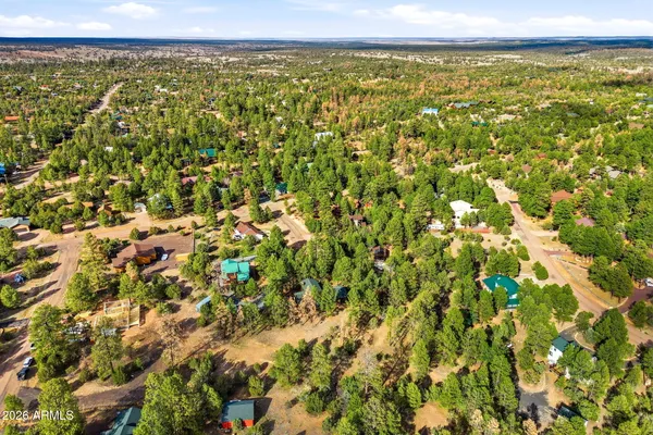 an aerial view of a house with a yard and a garden