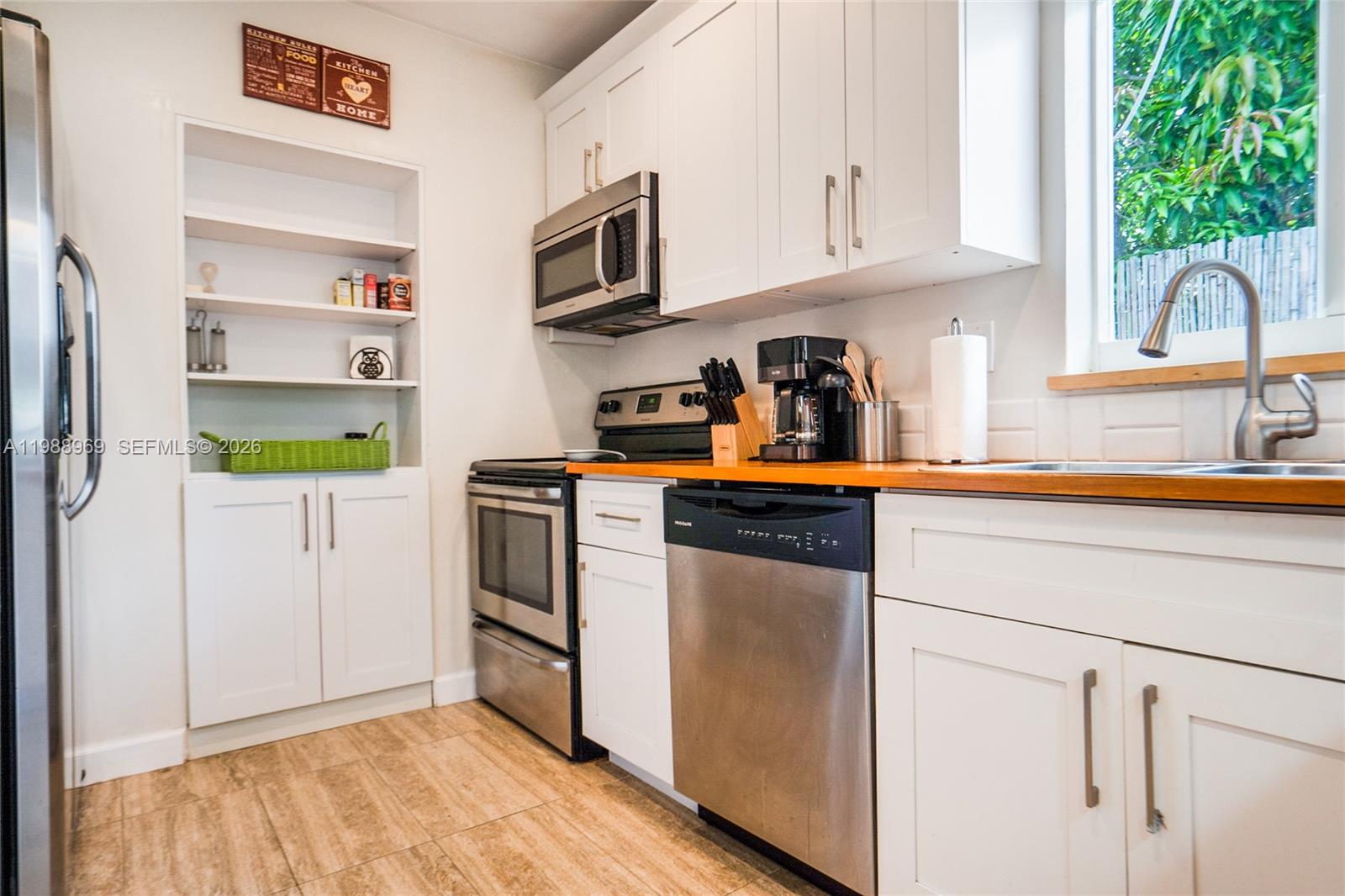 113 Southwest 2nd Street Hallandale Beach, FL 33009 - Photo 11 of 50 a kitchen with stainless steel appliances granite countertop a refrigerator sink and stove