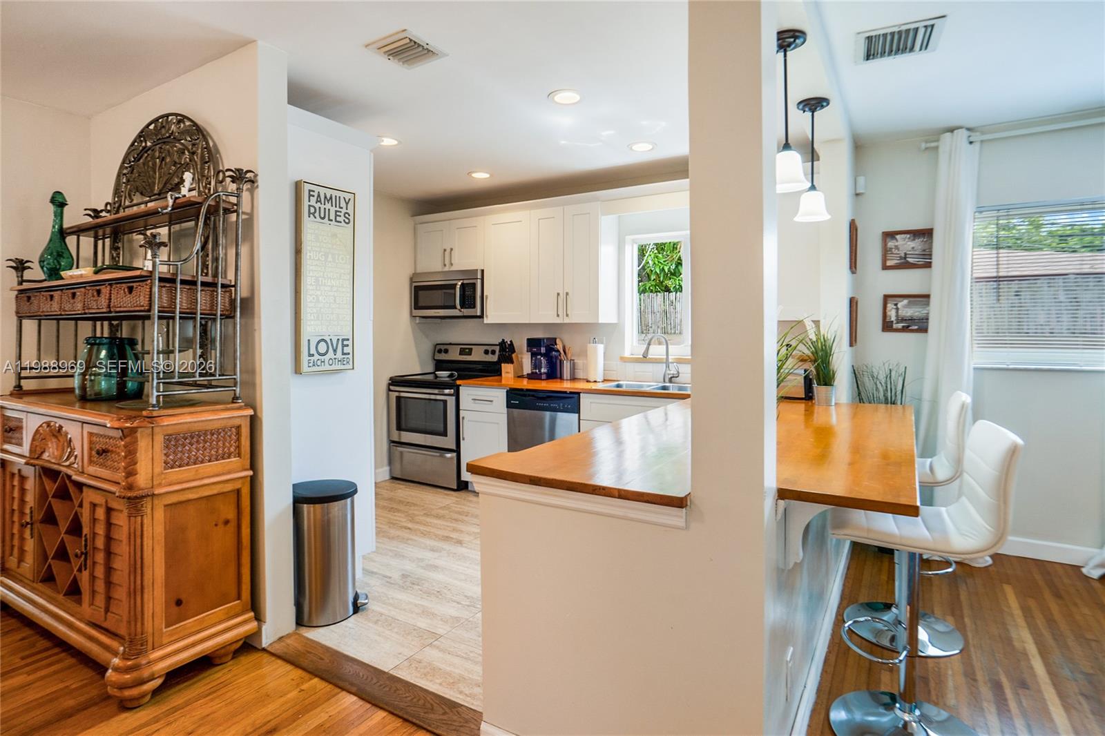 113 Southwest 2nd Street Hallandale Beach, FL 33009 - Photo 13 of 50 a kitchen with stainless steel appliances granite countertop a refrigerator and a stove top oven