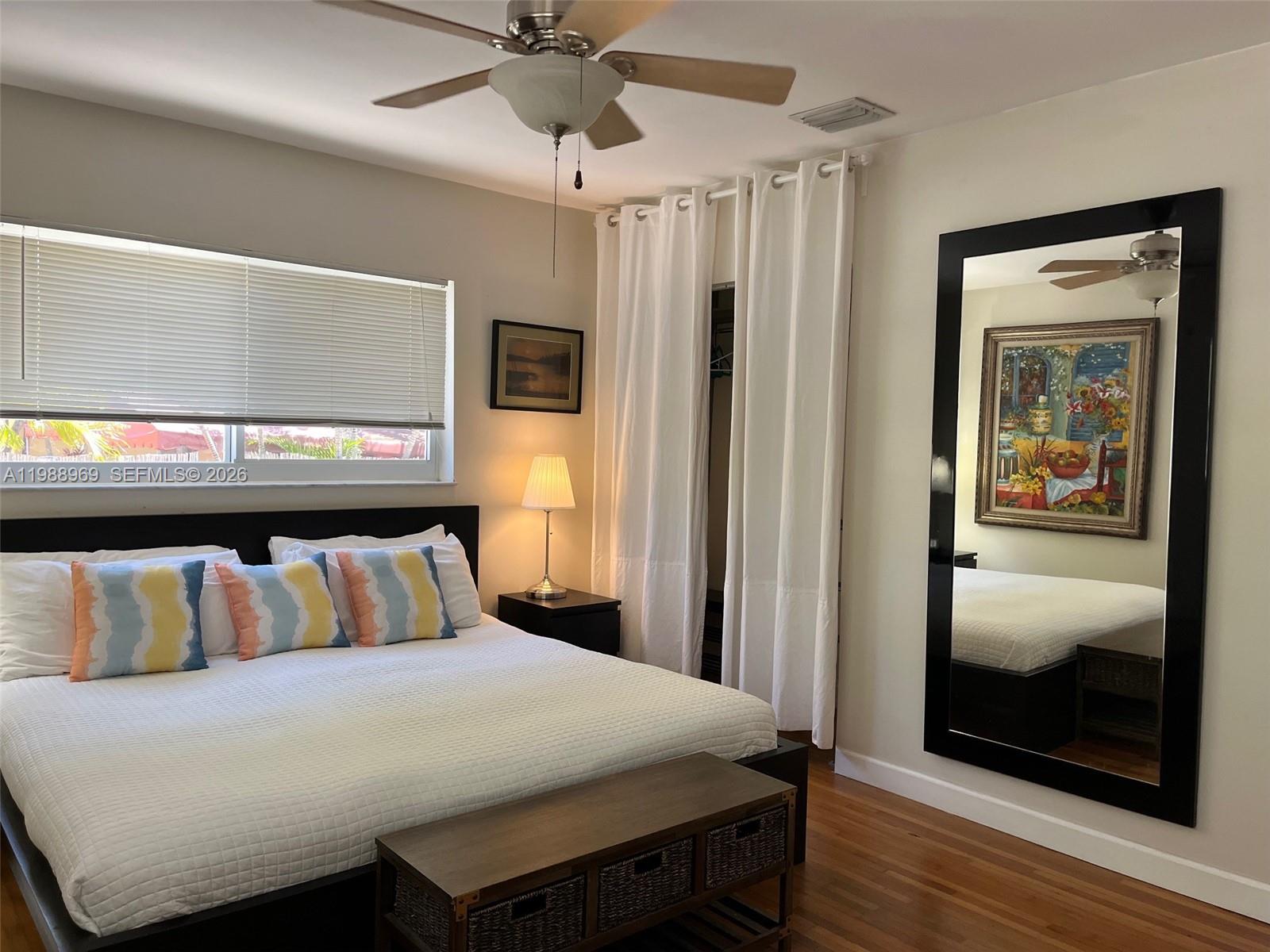 113 Southwest 2nd Street Hallandale Beach, FL 33009 - Photo 18 of 50 a bedroom with a bed and a mirror